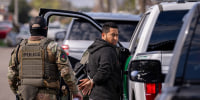 A person is detained by U.S. Customs and Border Patrol in New Orleans on Dec. 3, 2025.